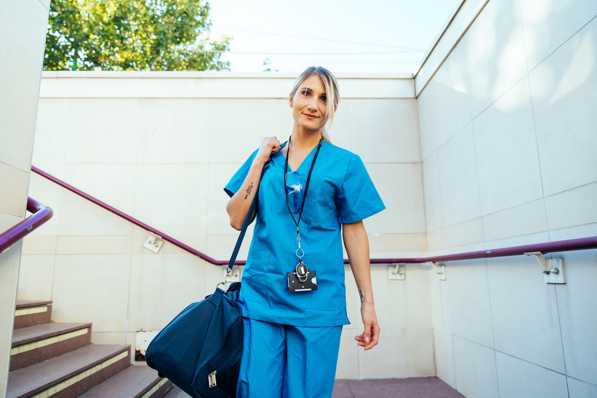 female travel nurse depicted traveling with large bag