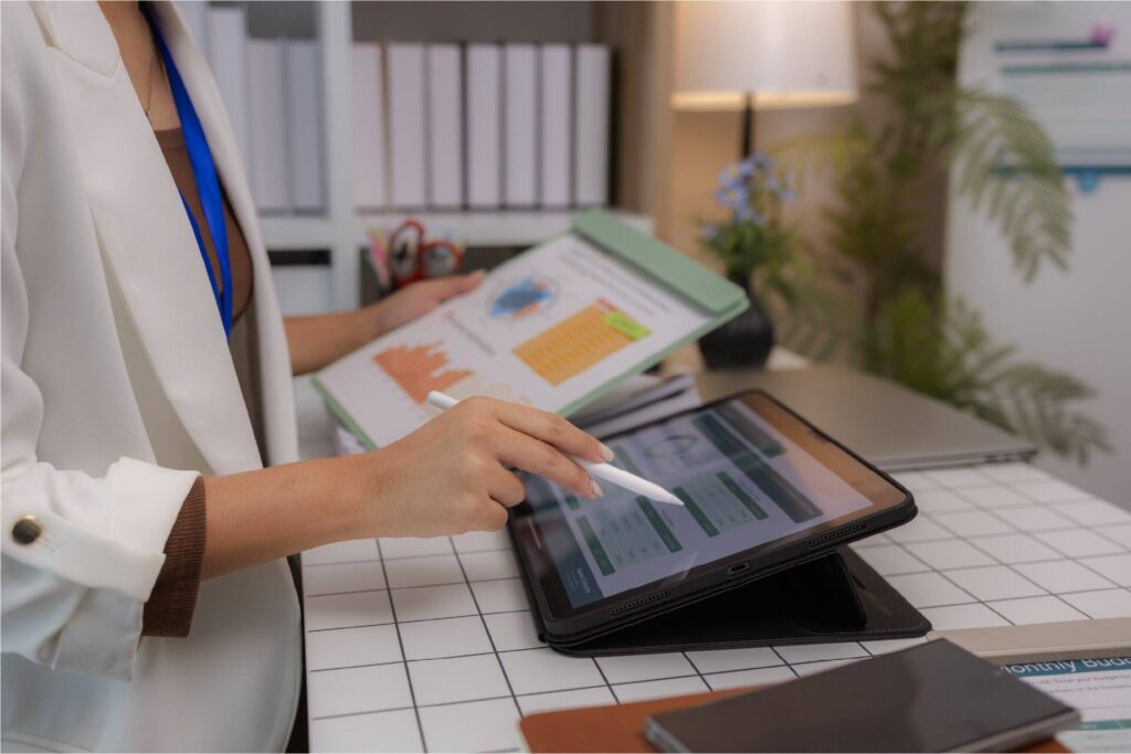 Healthcare administrator reviewing ASC staffing costs and margins on a tablet