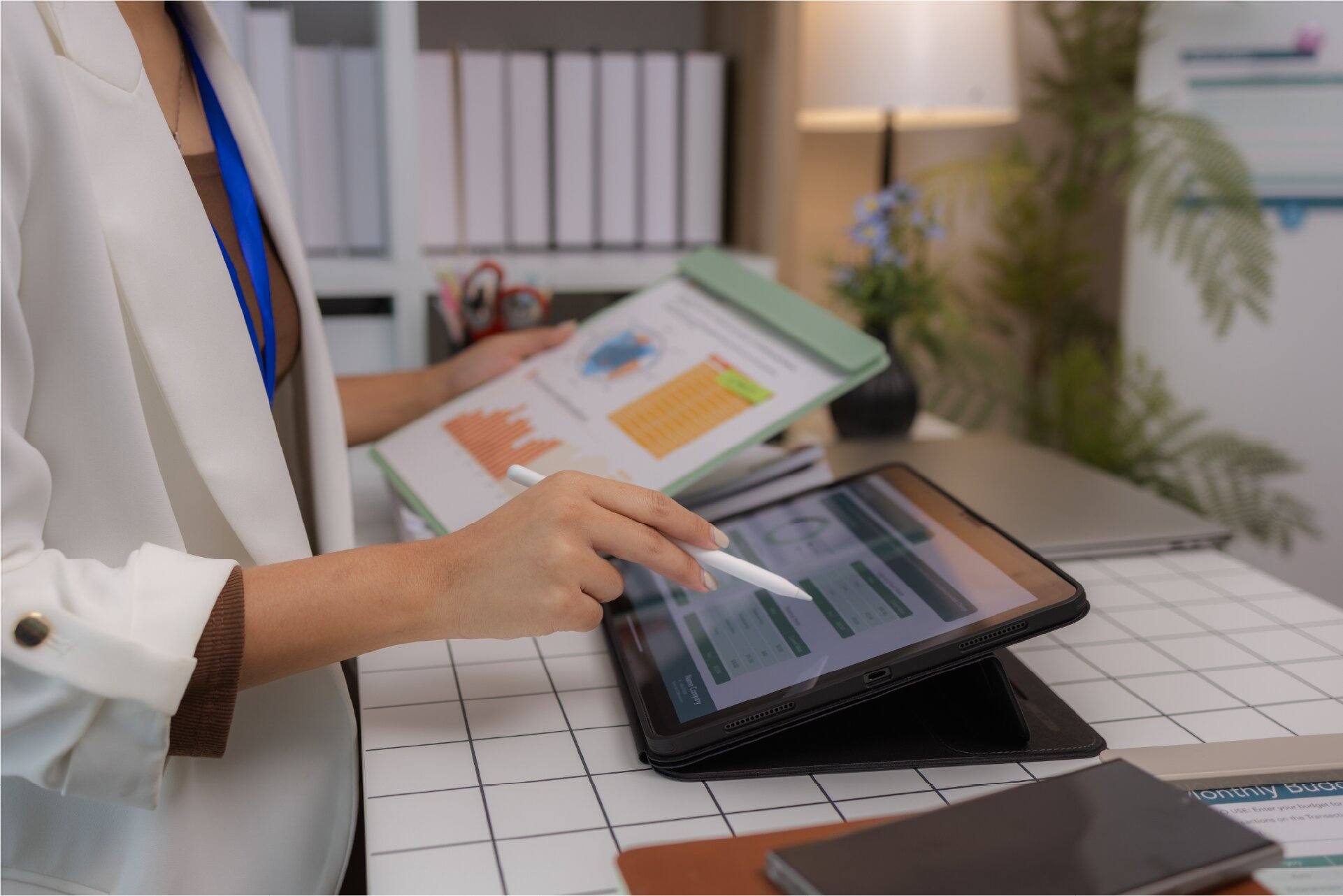 Healthcare administrator reviewing ASC staffing costs and margins on a tablet