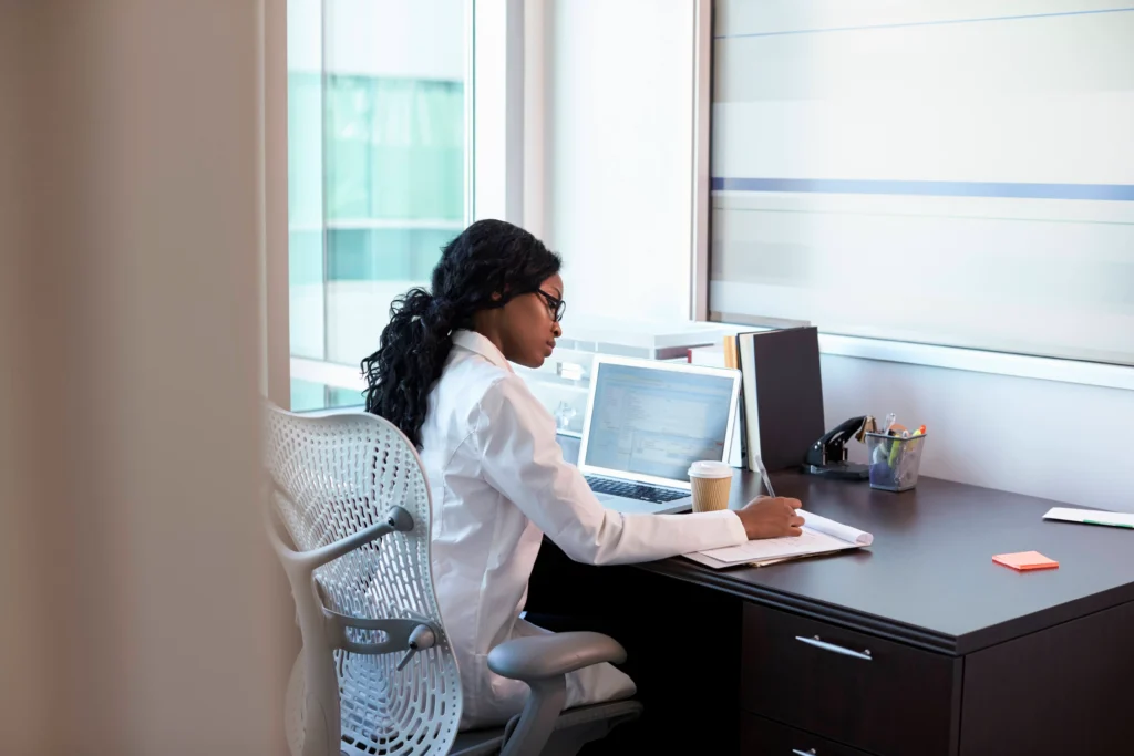 Healthcare staffing administrator reviewing contingent labor operations on a laptop