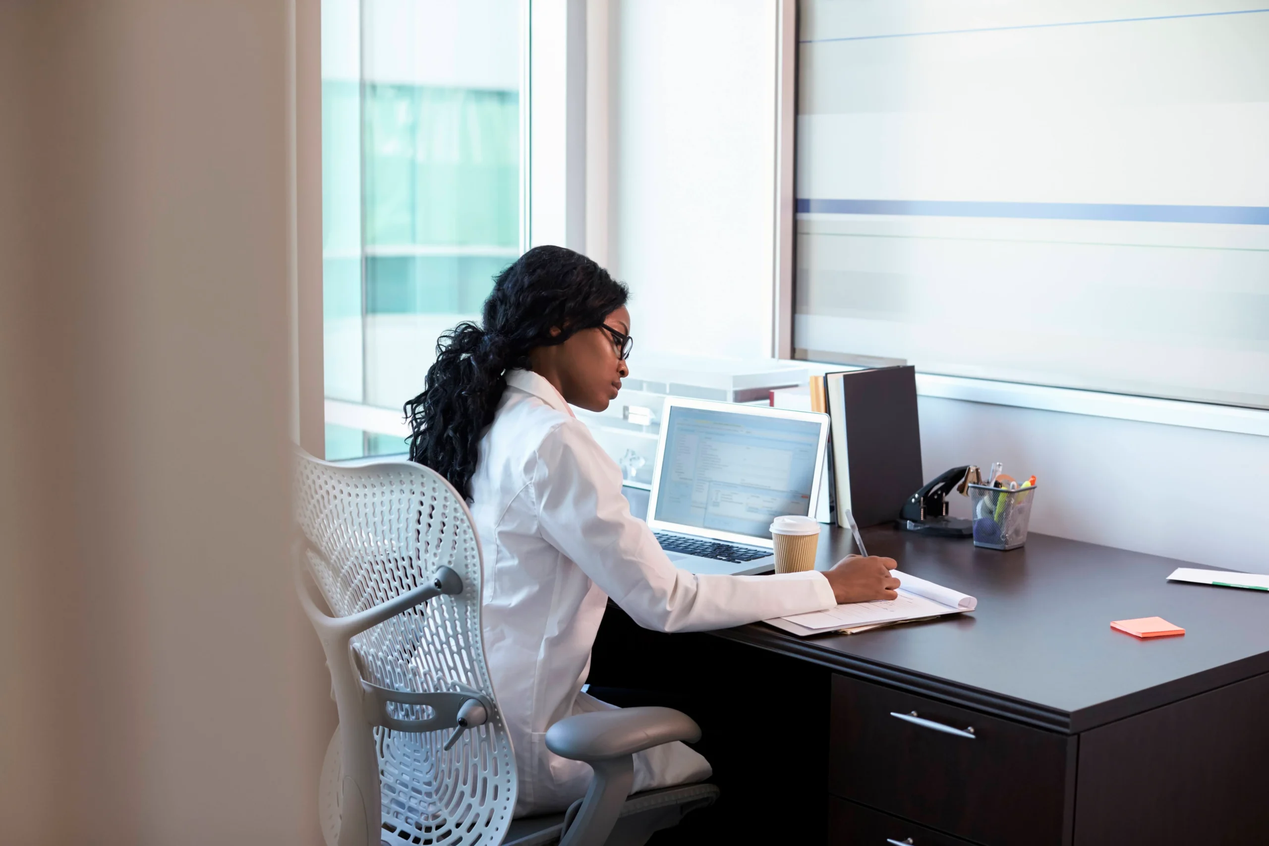 Healthcare staffing administrator reviewing contingent labor operations on a laptop